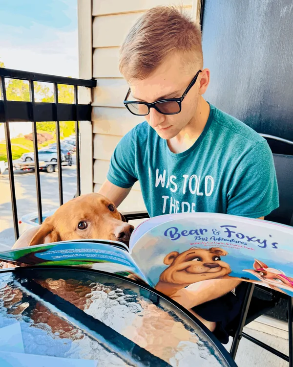 A young reader with Bear and Foxy's Big Adventures