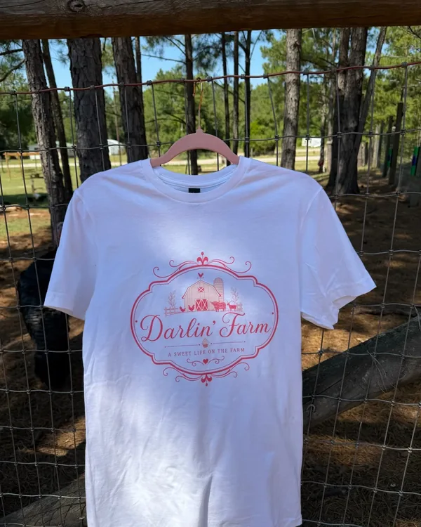 White Darlin' Farm shirt with the pink farm crest