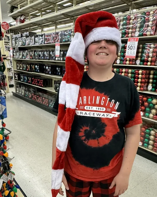 B Darlin' in a Santa hat in a store aisle