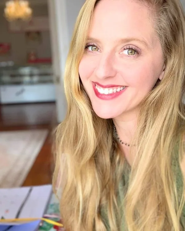 Ms. Darlin', smiling, with long blonde hair